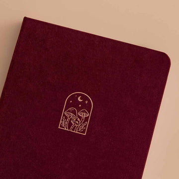 Close up of the front cover of Tsuki ‘Kinoko’ Limited Edition Bullet Journal on beige background